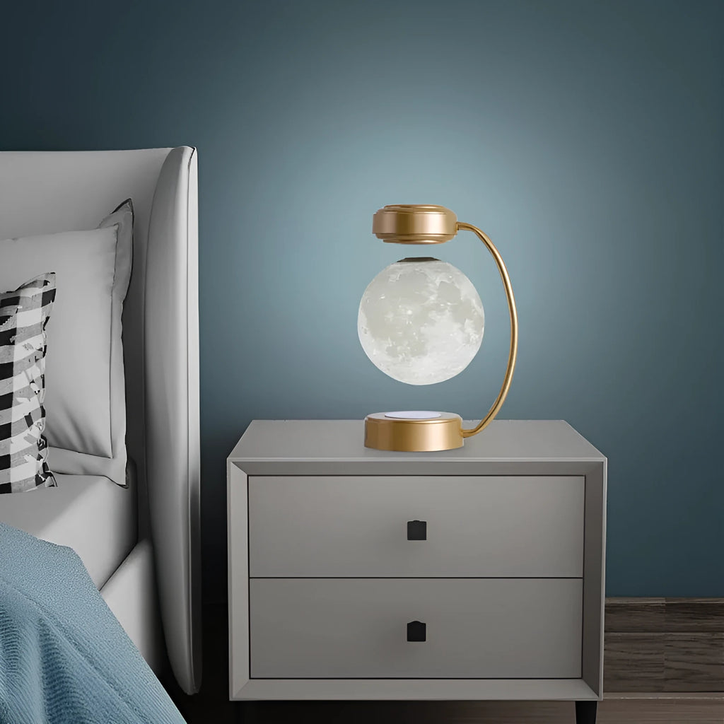 Black magnetic levitation moon lamp floating above its base with warm golden light.