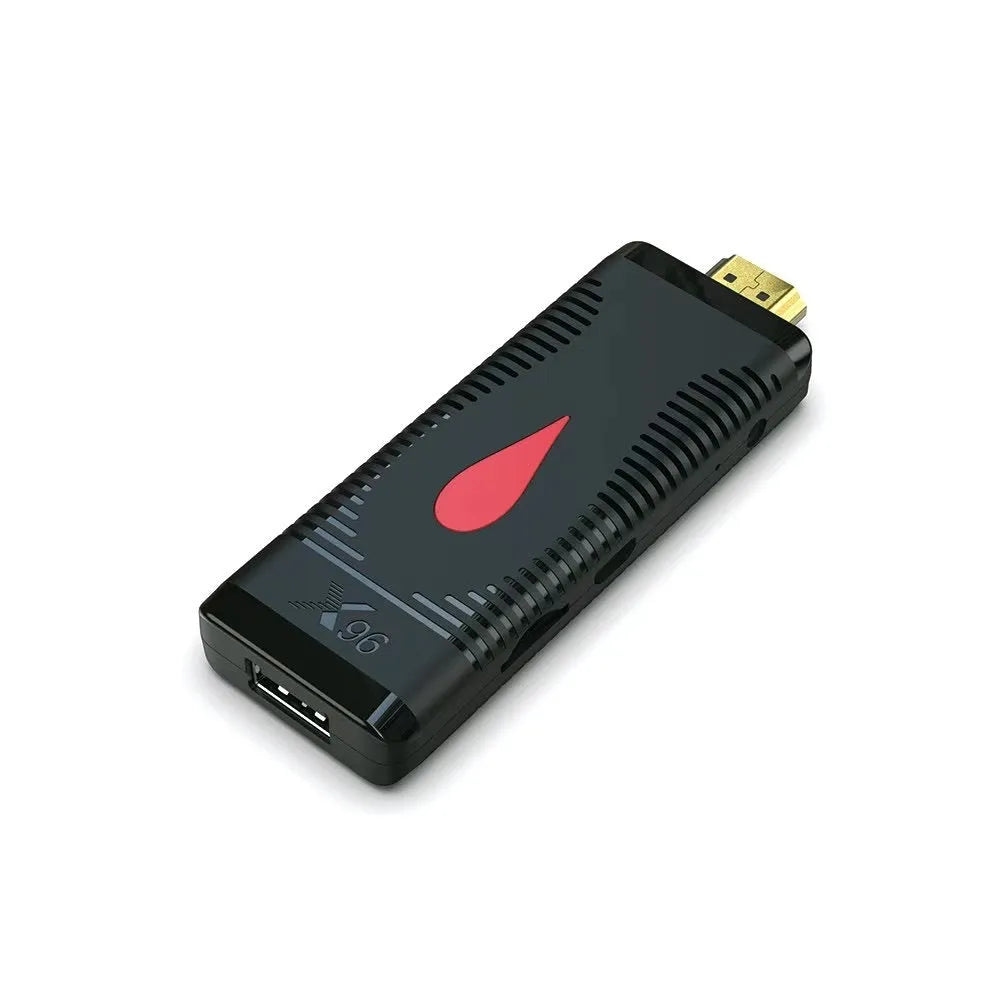 Small black Android TV set-top box dongle with remote control, power supply, and HDMI cable.