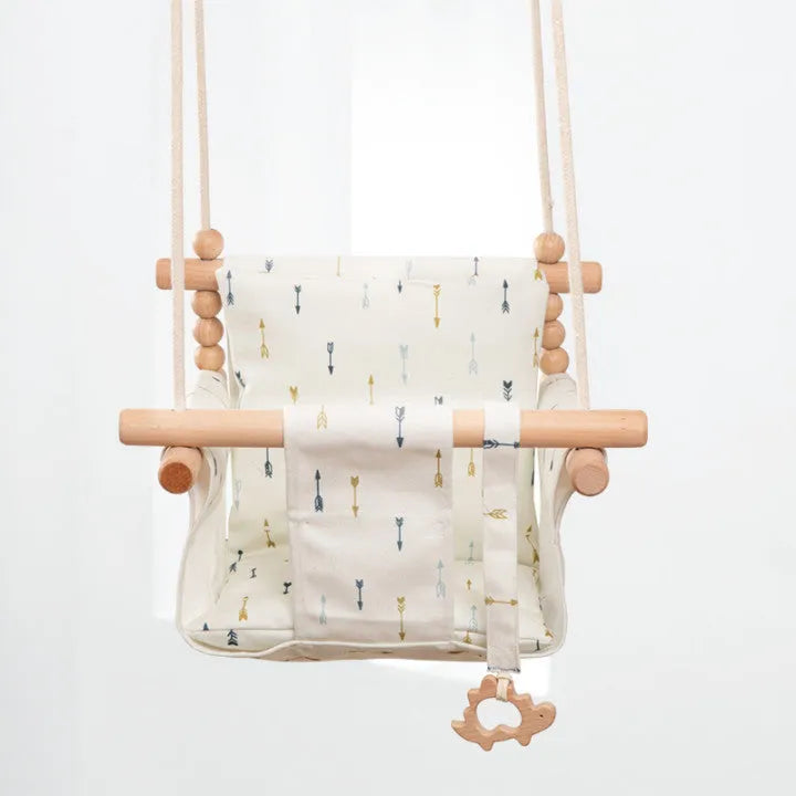 Cotton canvas baby swing chair with wooden seat hanging indoors