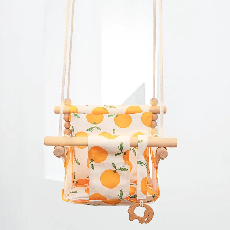 Cotton canvas baby swing chair with wooden seat hanging indoors