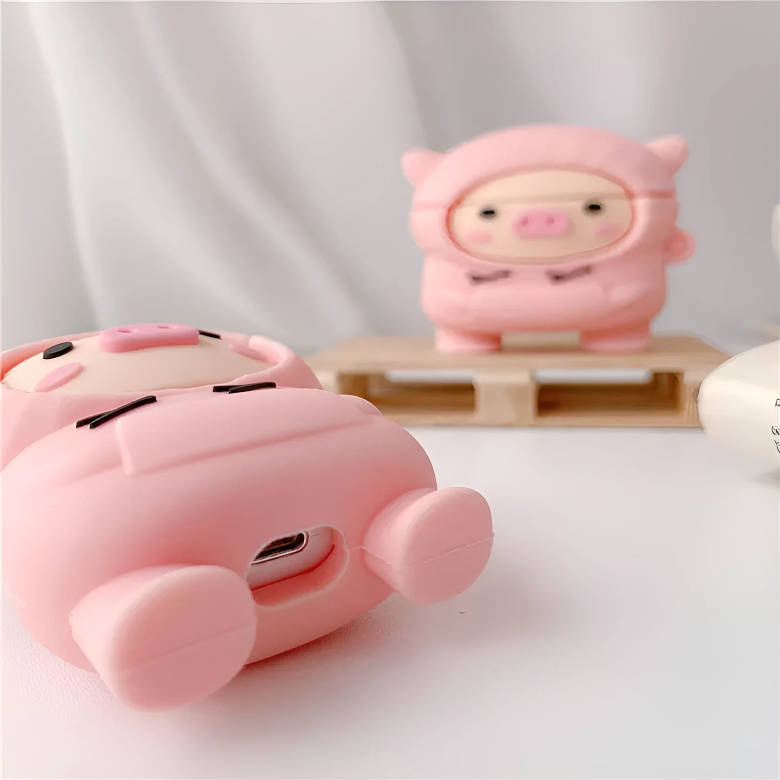 Pink cartoon pig silicone flip case with hook for Apple AirPods 1, 2, and Pro earphones.