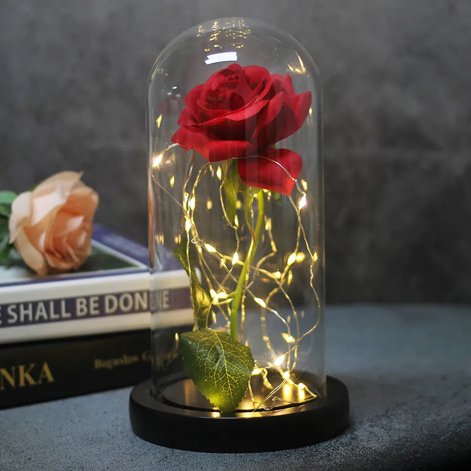 Immortal simulation rose bouquet in glass cover with warm LED light on a tabletop