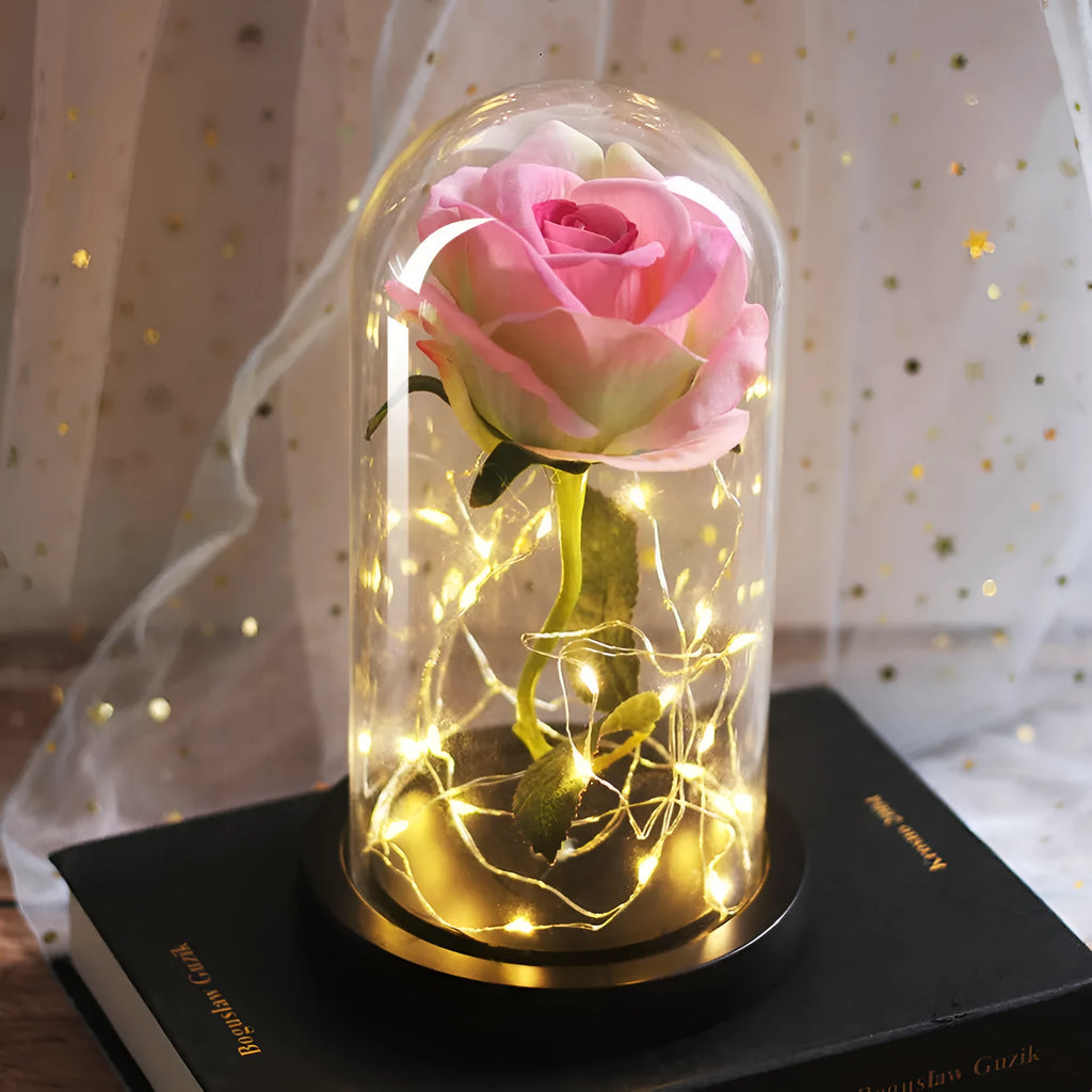 Immortal simulation rose bouquet in glass cover with warm LED light on a tabletop