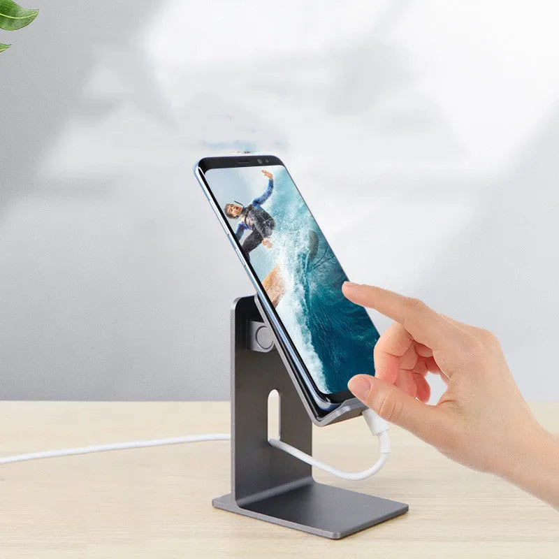 Dark Space Gray alloy desktop mobile phone and tablet holder on a wooden desk.