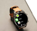 Black smart watch with 1.6 inch screen showing heart rate monitoring display and dual camera lenses visible on watch case