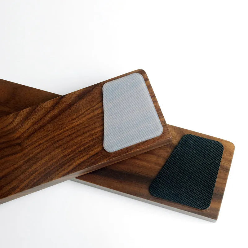Solid walnut wood wrist rest for a mechanical keyboard on a desk.