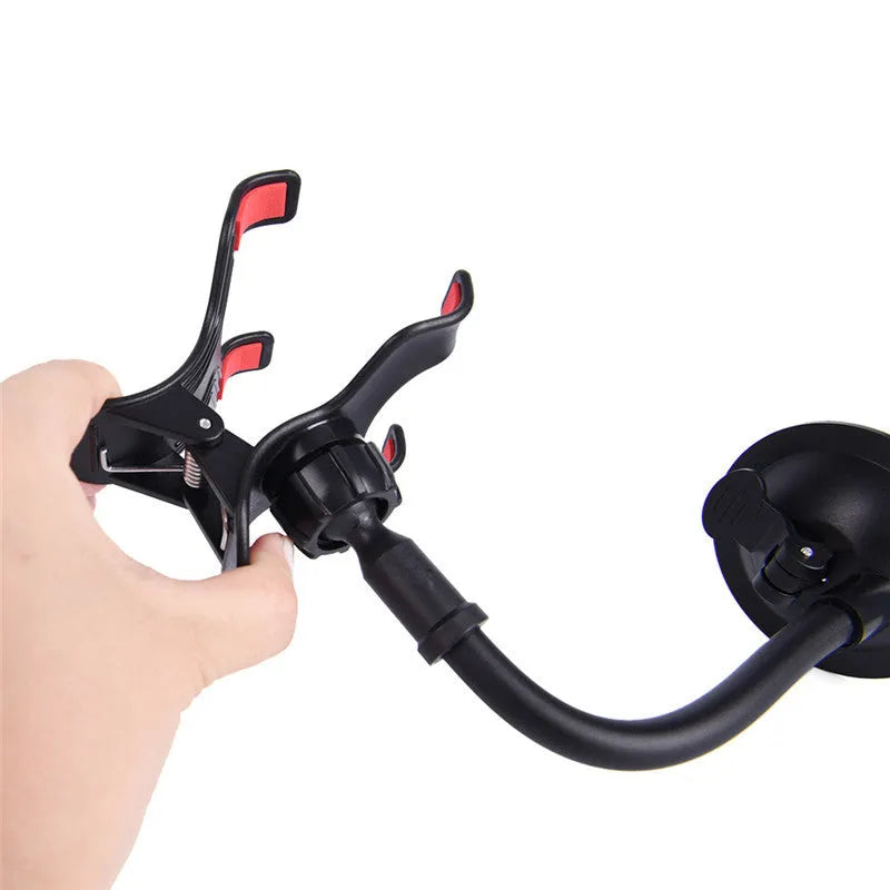 Black car phone holder with suction cup attached to windshield showing 360-degree rotation and device clamp