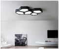 Geometric shaped wall light with black or white iron frame and push-button control.