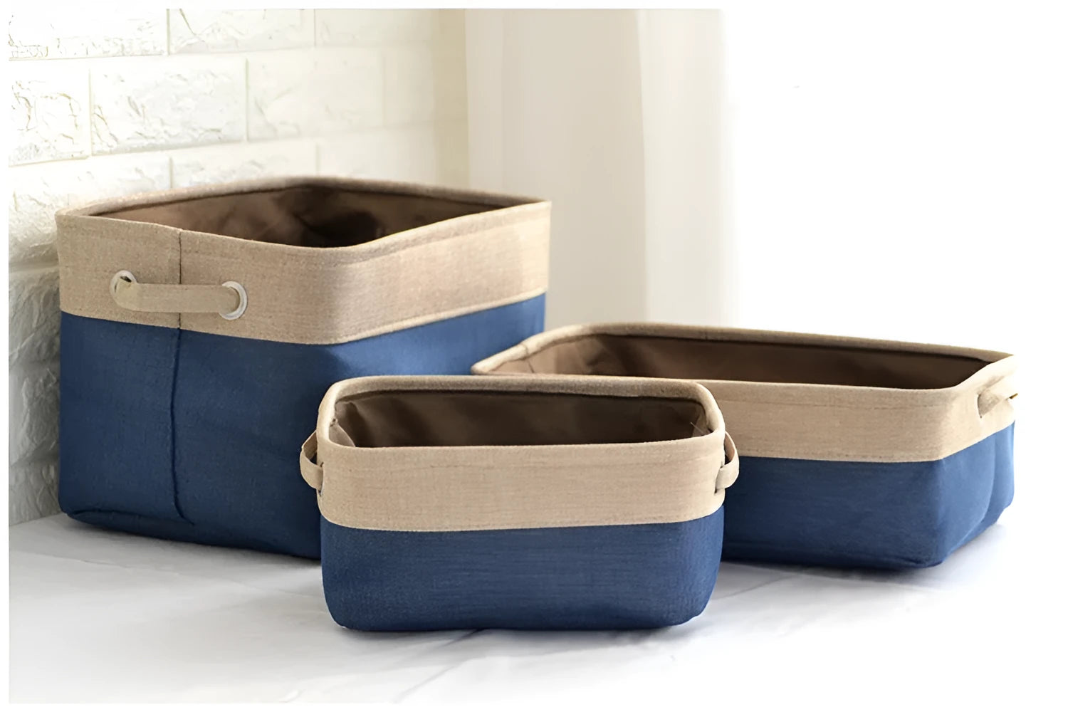 Blue foldable fabric storage basket shown next to folded clothes and a book.