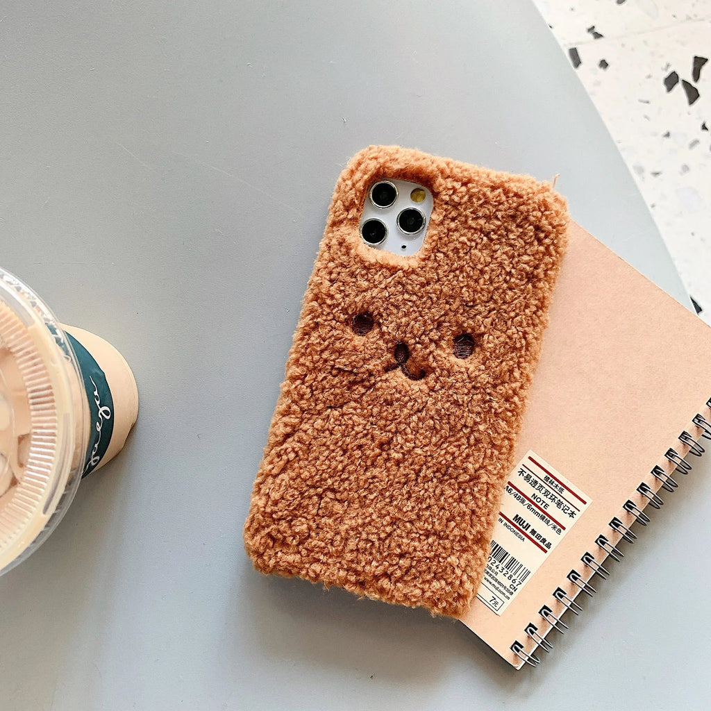 Brown plush bear embroidered iPhone case on a mobile phone