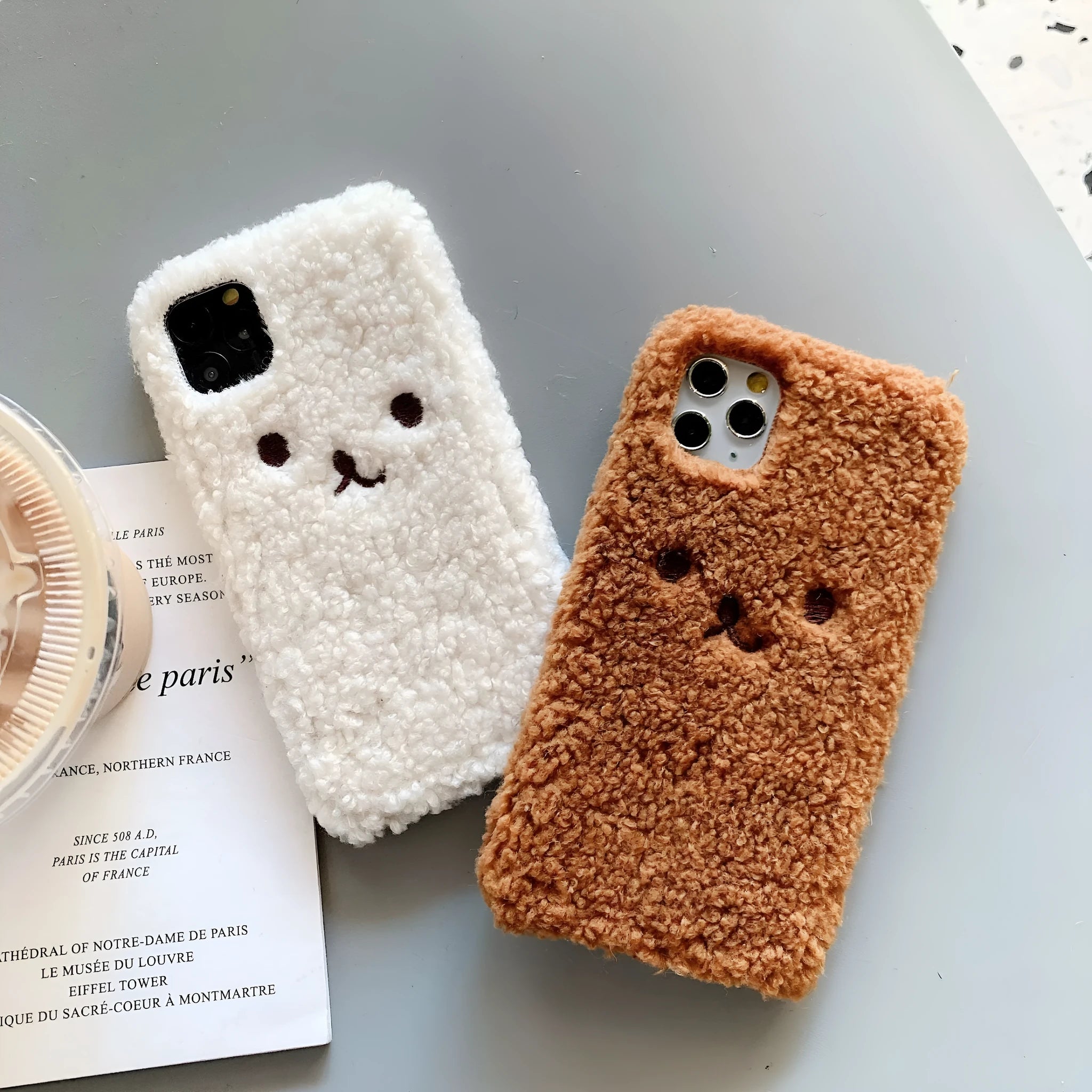 Brown plush bear embroidered iPhone case on a mobile phone