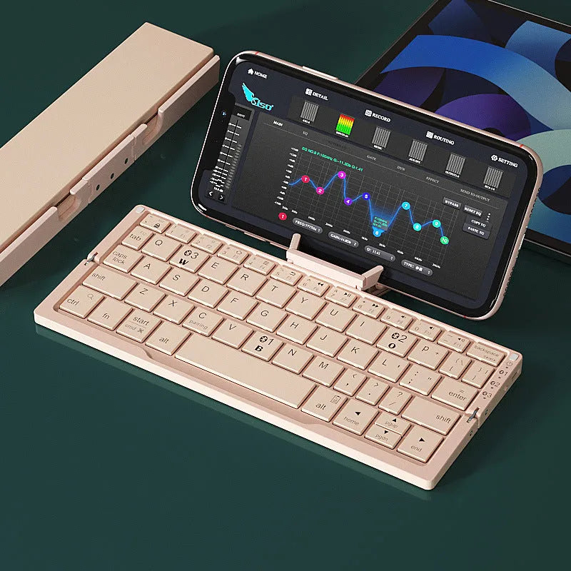 Silver aluminium foldable Bluetooth keyboard with stand holding smartphone