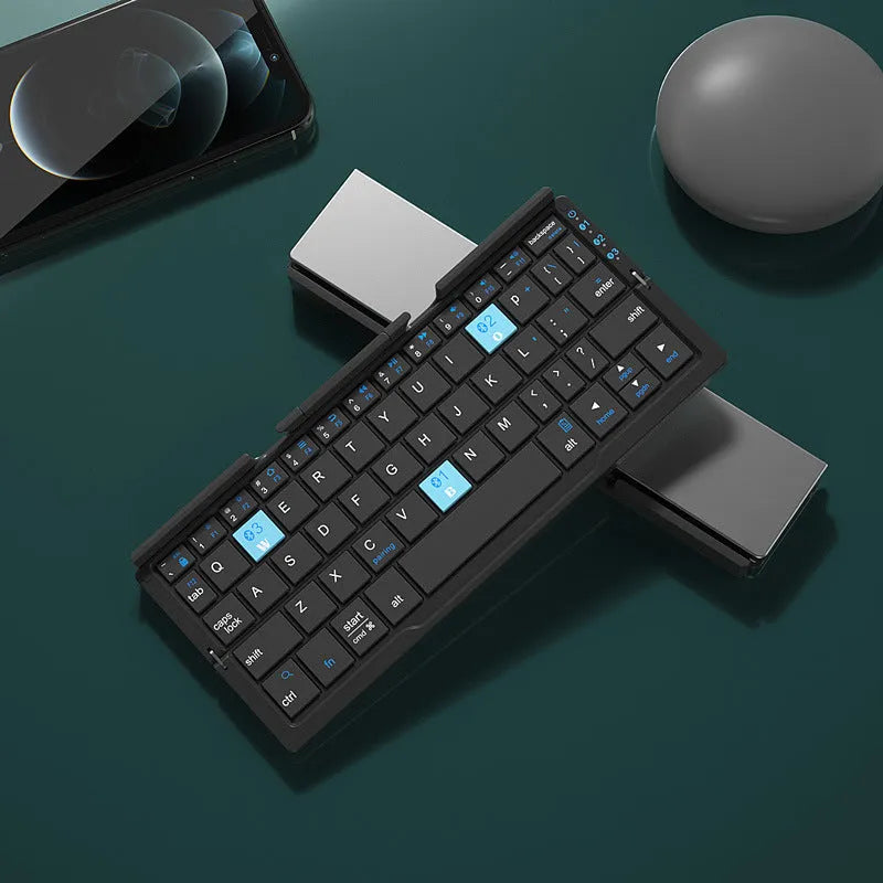 Silver aluminium foldable Bluetooth keyboard with stand holding smartphone