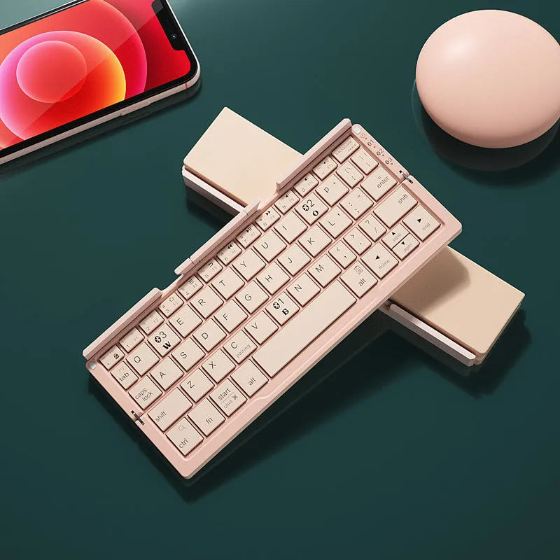 Silver aluminium foldable Bluetooth keyboard with stand holding smartphone