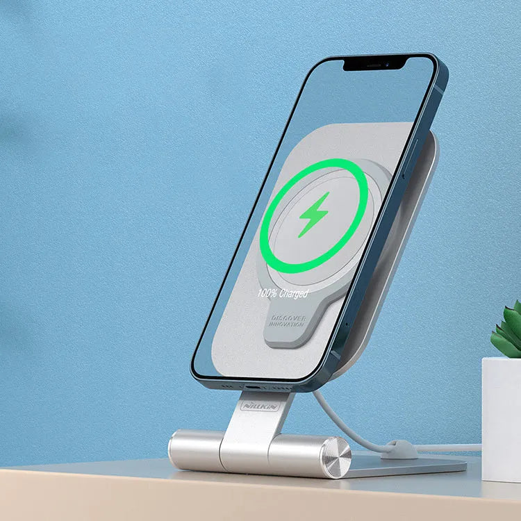Silver NILLKIN foldable aluminium alloy magnetic wireless charging stand for iPhone 12 Mini on a desk