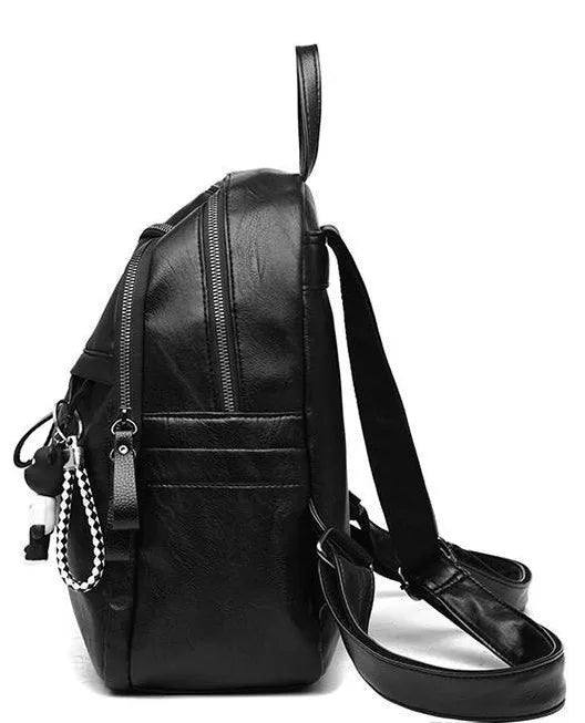 Black soft-surface PU leather backpack with double straps, shown with a pendant option.