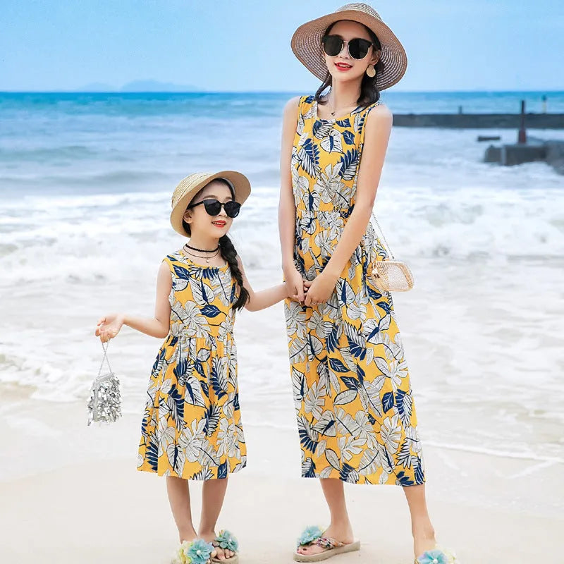 Mother and daughter wearing matching JWH vest and long skirt set in banana leaf print for beach vacation