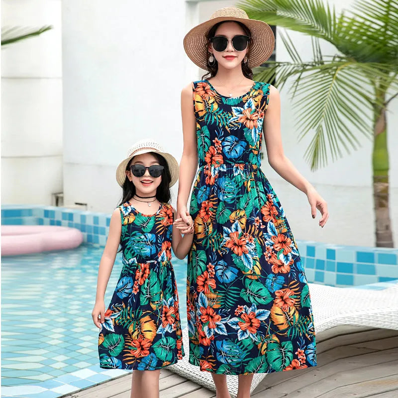 Mother and daughter wearing matching JWH vest and long skirt set in banana leaf print for beach vacation