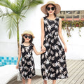 Mother and daughter wearing matching JWH vest and long skirt set in banana leaf print for beach vacation