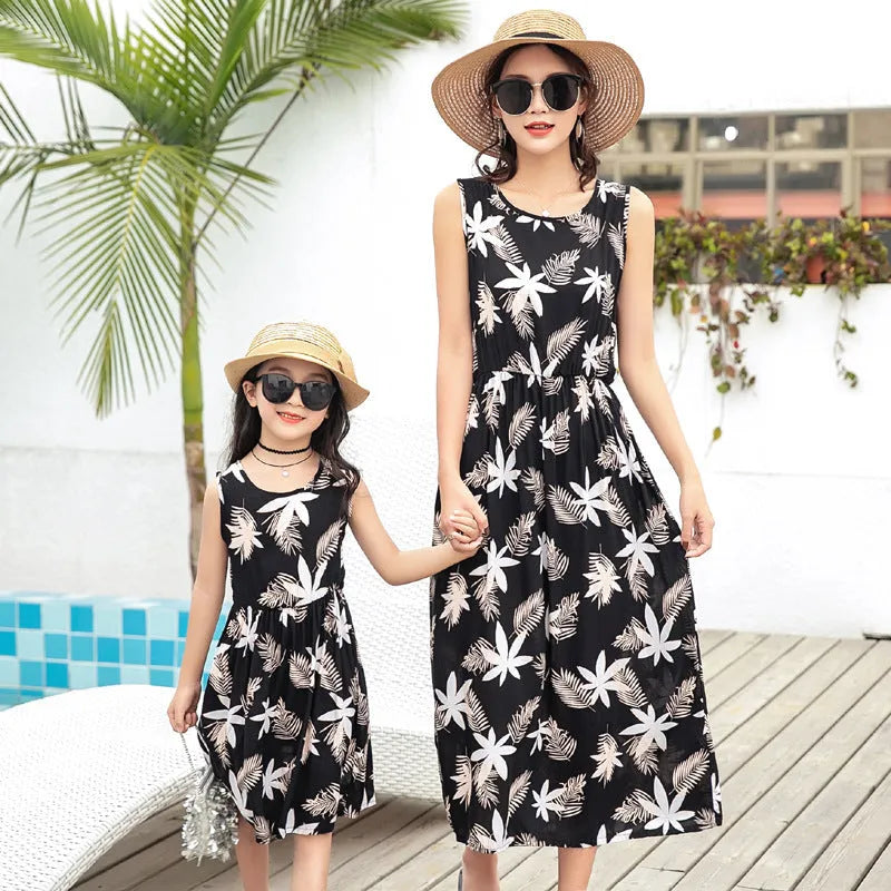 Mother and daughter wearing matching JWH vest and long skirt set in banana leaf print for beach vacation