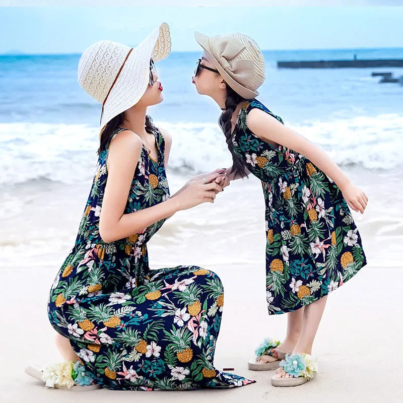 Mother and daughter wearing matching JWH vest and long skirt set in banana leaf print for beach vacation