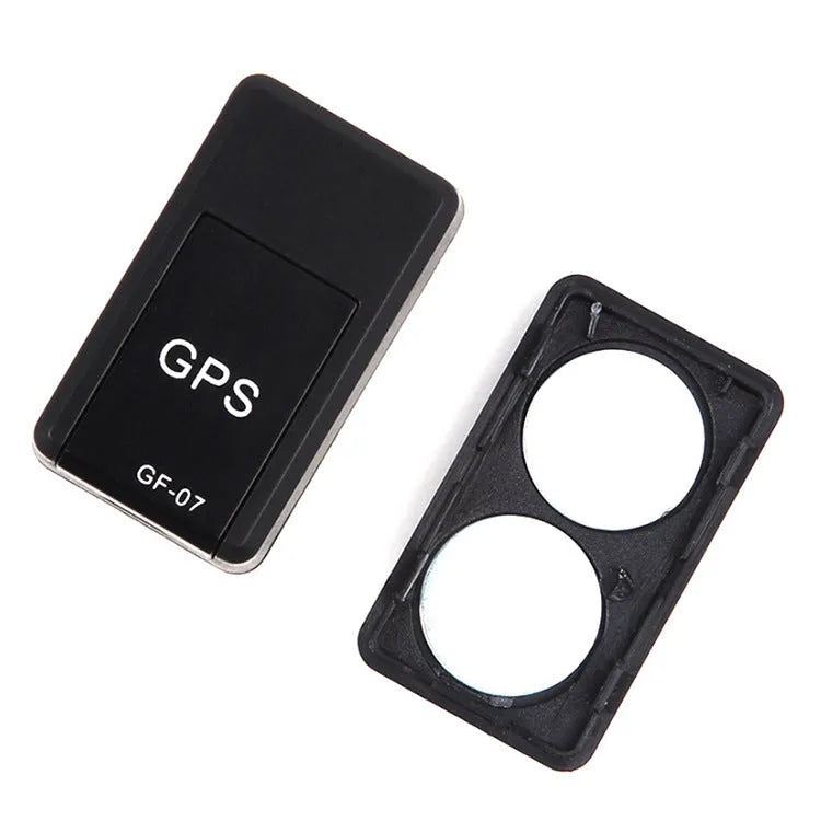 Small black magnetic GPS tracker device next to a USB charging cable.