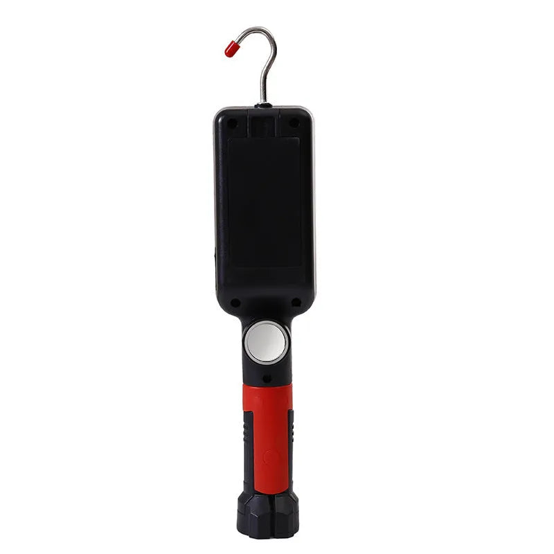 Red portable USB rechargeable COB camping lamp with magnetic hook on a metal surface.