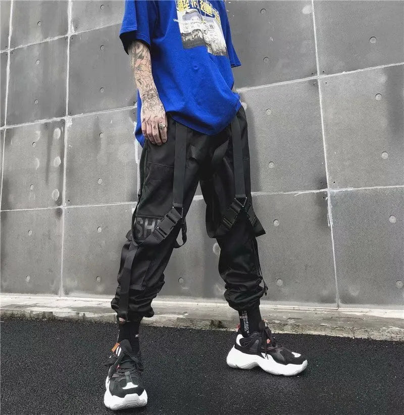 Black functional overalls for men with loose paratrooper-style fit and straight trousers, front view