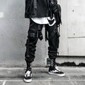 Black functional overalls for men with loose paratrooper-style fit and straight trousers, front view
