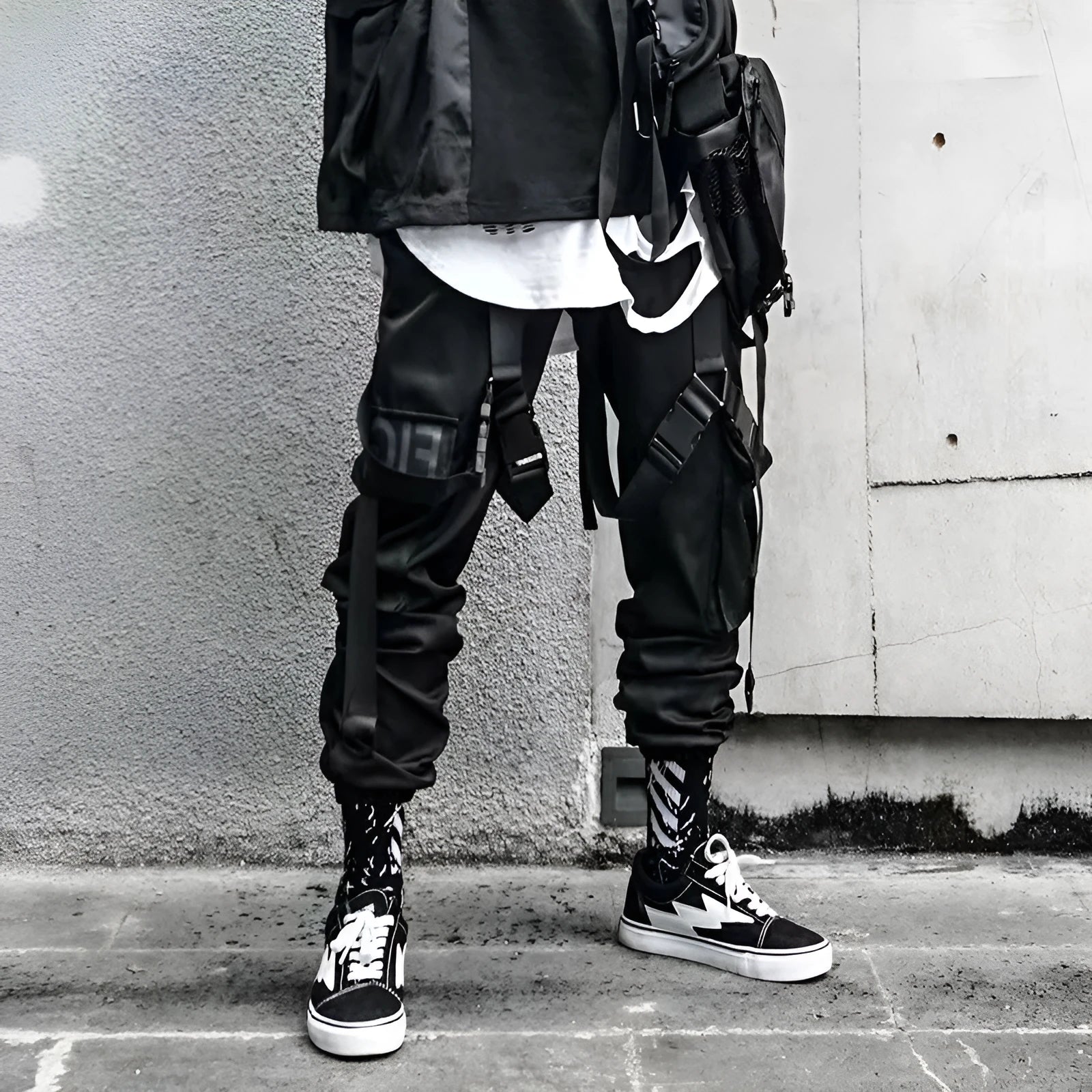 Black functional overalls for men with loose paratrooper-style fit and straight trousers, front view