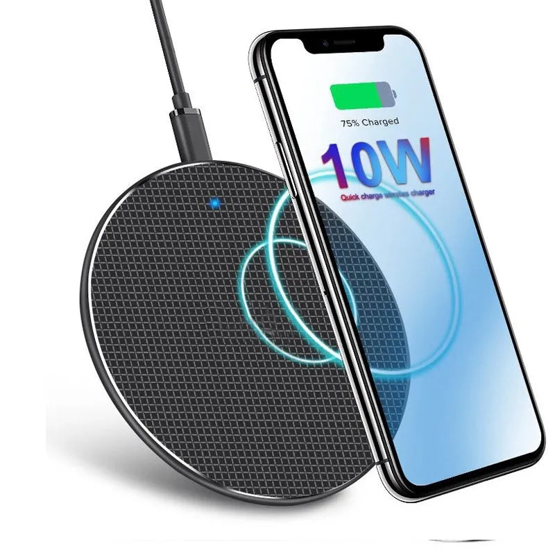 Round black wireless phone charger with aluminum base and Qi receiver on grey surface