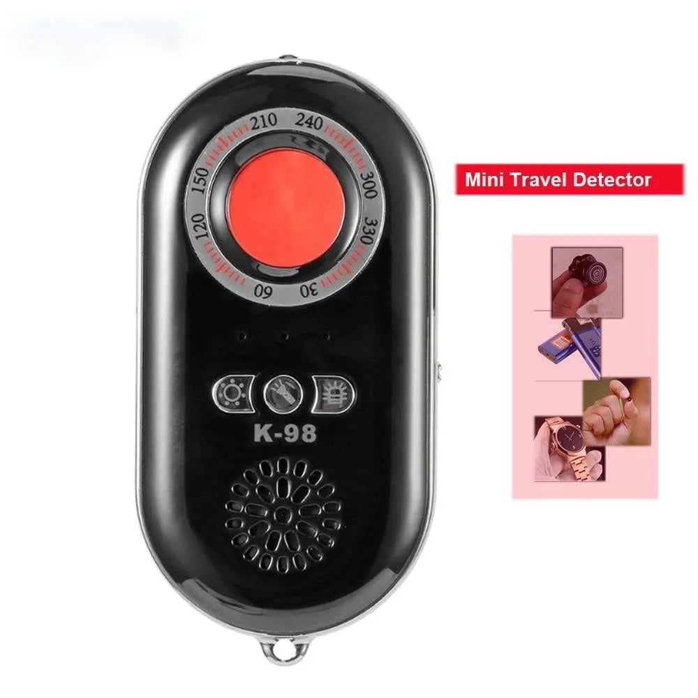 Compact black wireless signal detector with vibration alarm for travel security, shown next to a ruler for scale.