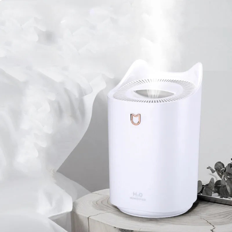 Coral pink double spray humidifier with large water tank and three mist outlets on a table.