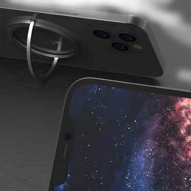 Portable round zinc alloy mobile phone holder in black on a desk for wireless charging