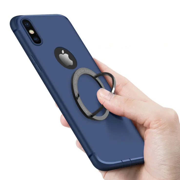 Portable round zinc alloy mobile phone holder in black on a desk for wireless charging