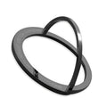Portable round zinc alloy mobile phone holder in black on a desk for wireless charging