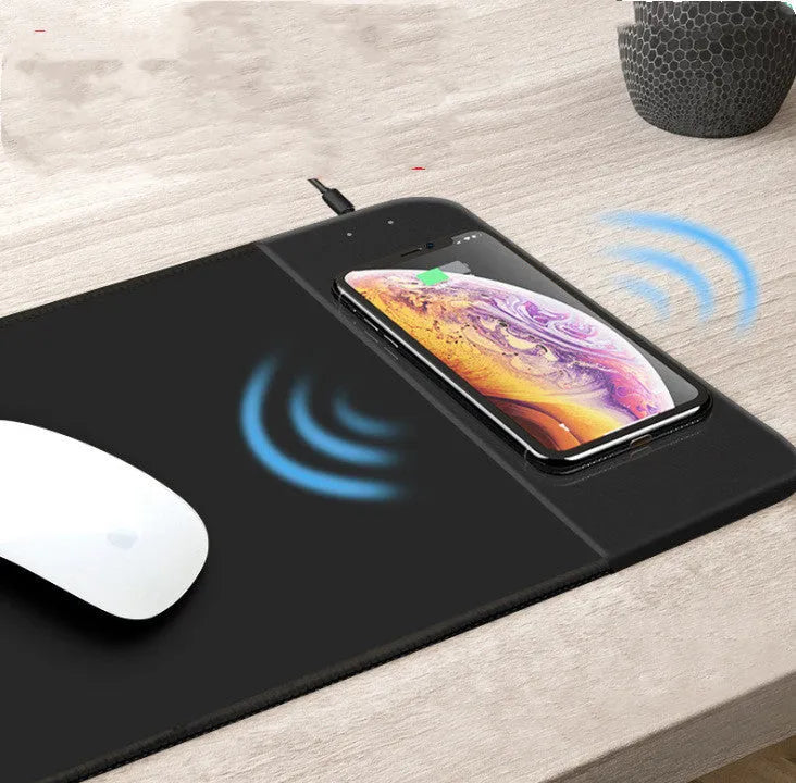 Wireless charging mouse pad with RGB lighting and cartoon design, showing cloth surface and rubber base