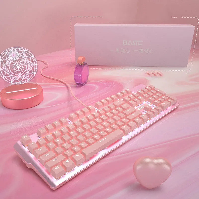 Pink mechanical keyboard and wired mouse gaming set with USB connections on pink background