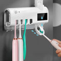 Black wall-mounted UV toothbrush steriliser and automatic toothpaste squeezer unit with solar panel.