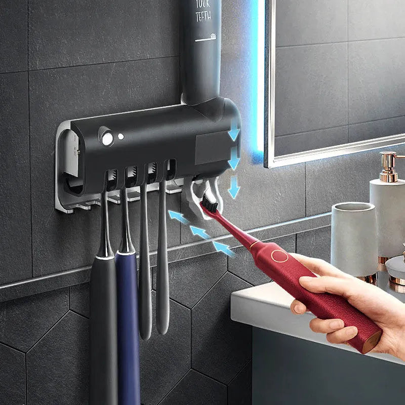 Black wall-mounted UV toothbrush steriliser and automatic toothpaste squeezer unit with solar panel.