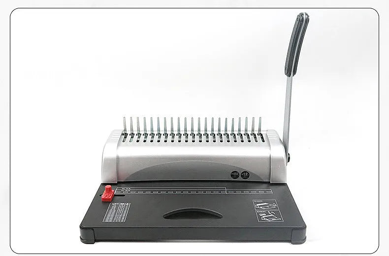 White A4 manual comb binding machine with 21-hole clamp strip punching mechanism on desk