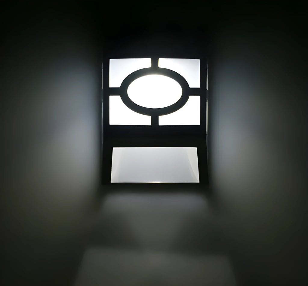 Compact white plastic solar wall light with solar panel and LED light lens.