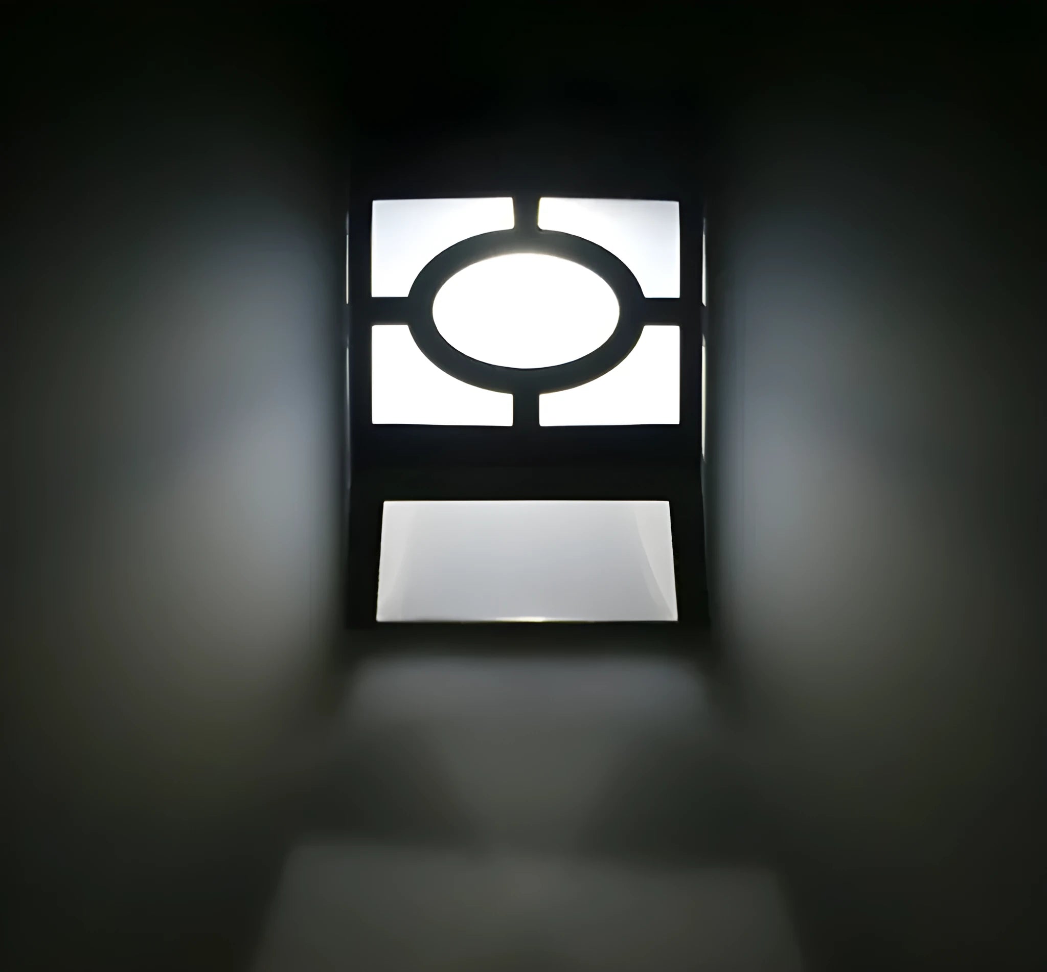 Compact white plastic solar wall light with solar panel and LED light lens.