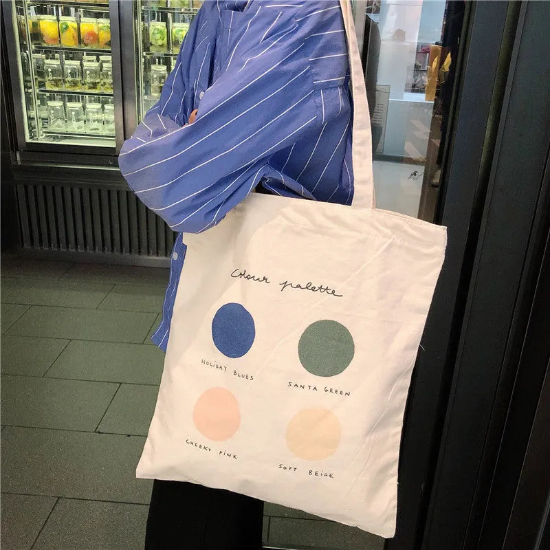 Light pink geometric print women's canvas tote bag with double shoulder straps and a zipper closure.