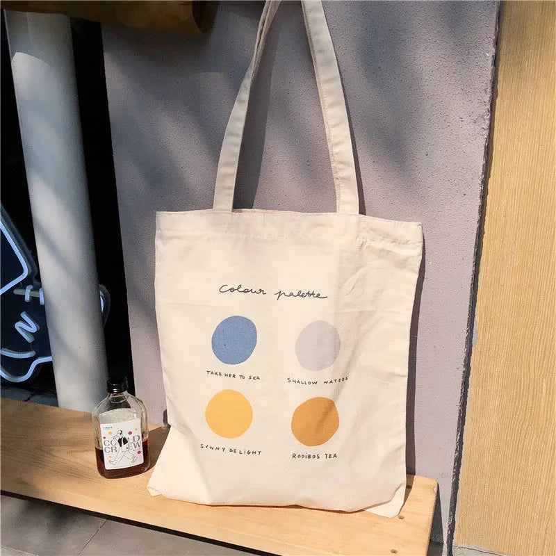 Light pink geometric print women's canvas tote bag with double shoulder straps and a zipper closure.