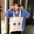Light pink geometric print women's canvas tote bag with double shoulder straps and a zipper closure.