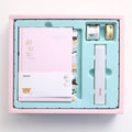 Peekaboo hand ledger journal notebook with pen, shown in blue, green, pink, and purple colour options.