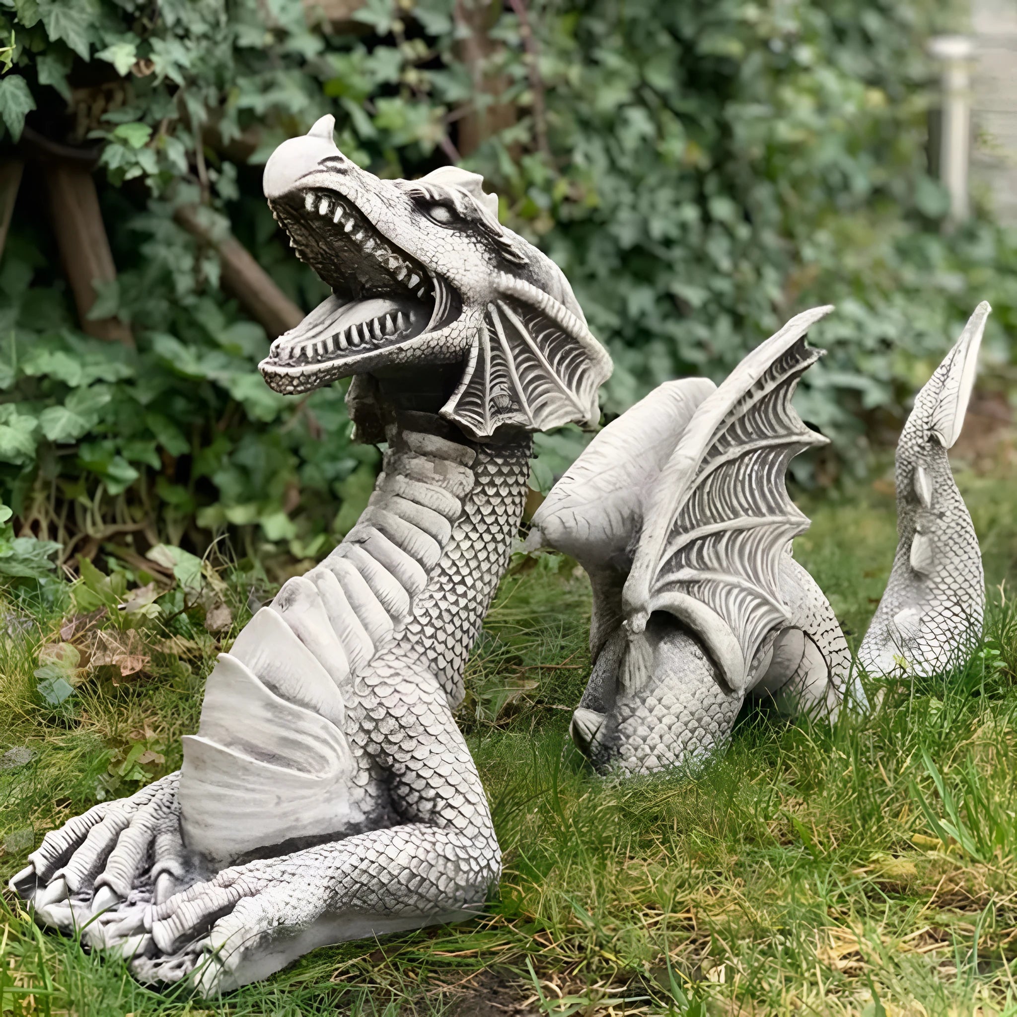 Large gothic dragon garden statue in charcoal grey resin with wings and tail, placed on a lawn