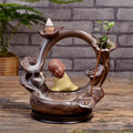 Ceramic backflow incense burner in Zen Lotus Pond Yellow with traditional pottery finish on a wooden table