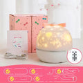 Pink and rose red rotating starry night light projector with six film discs on a table.